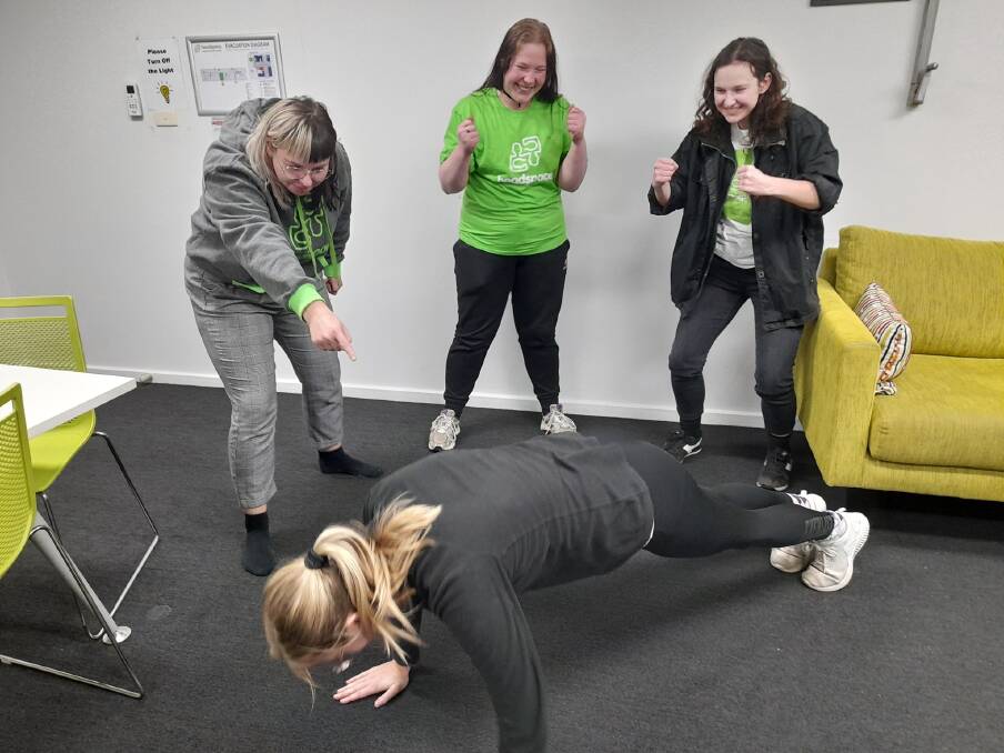 Jenna Ross, Jess Hall, Ash Ross encouraging Isi Archer to do a push up. Photo: Headspace Queanbeyan Facebook 